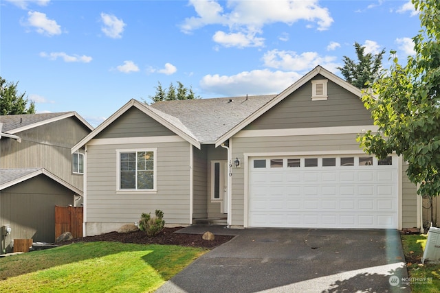 single story home featuring a front yard and a garage