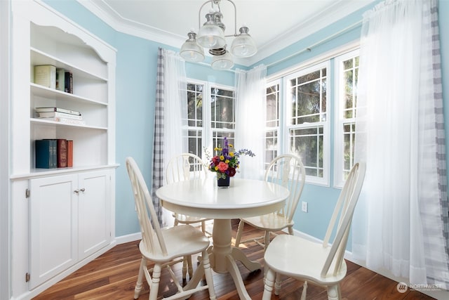 dining area featuring ornamental molding, a chandelier, and dark hardwood / wood-style flooring