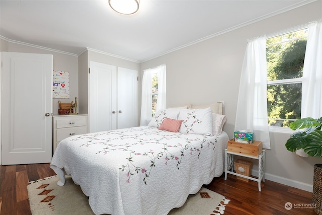 bedroom with ornamental molding and dark hardwood / wood-style flooring