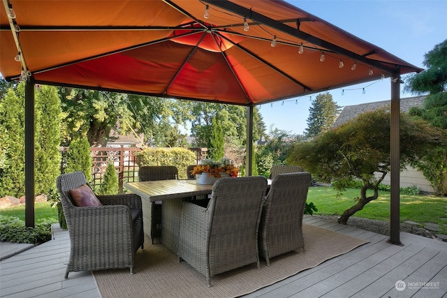 wooden terrace featuring a gazebo and a yard