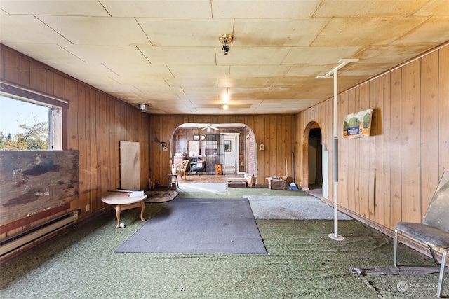 interior space featuring wood walls and carpet flooring