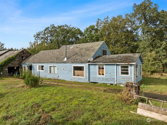 rear view of house with a yard