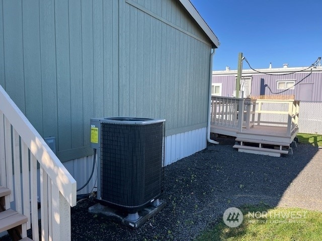 view of home's exterior featuring a wooden deck and central AC