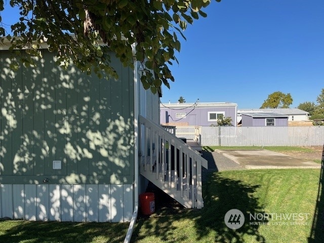 view of side of home with a lawn