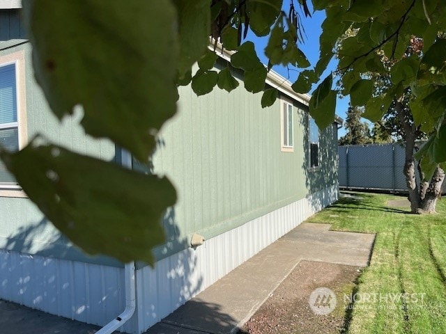 view of side of home featuring a lawn