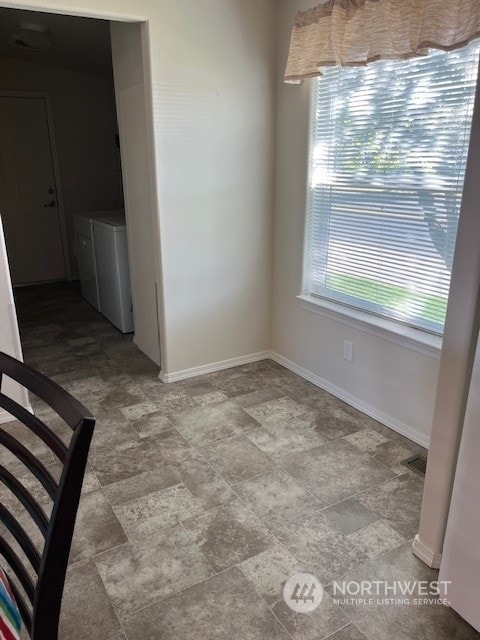 unfurnished dining area featuring independent washer and dryer