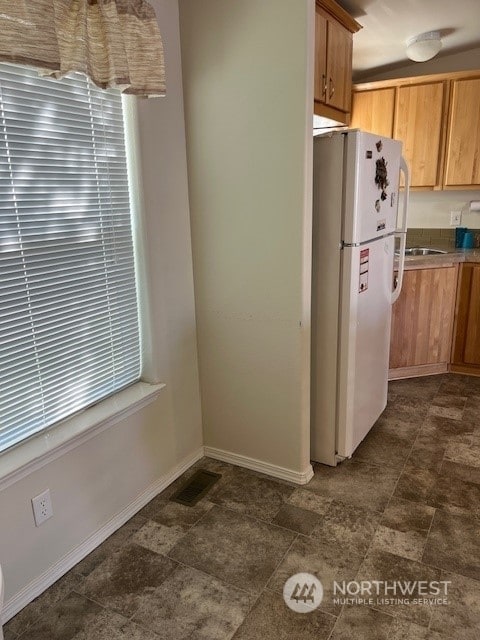 1257 Arkansas Dr, Walla Walla, WA 99362 - kitchen featuring freestanding refrigerator, baseboards, and stone finish flooring