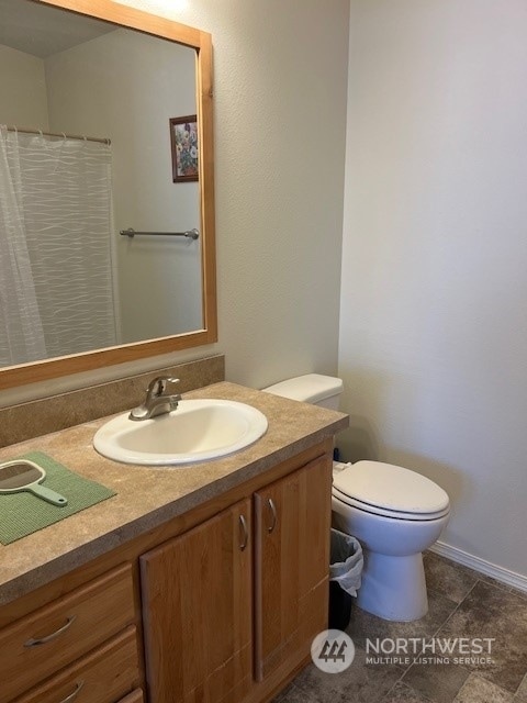 bathroom featuring vanity, toilet, and tile patterned floors