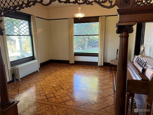 interior space with plenty of natural light, radiator heating unit, and light parquet floors