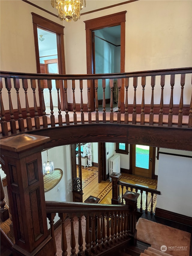 stairway with an inviting chandelier and a healthy amount of sunlight