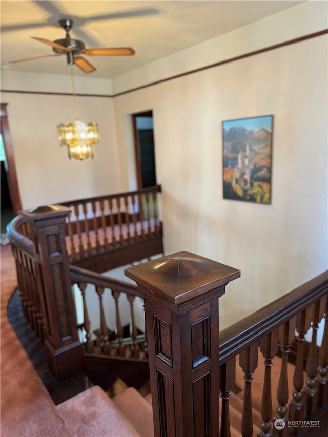 stairway featuring carpet floors and an inviting chandelier