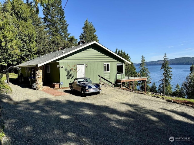 view of property exterior featuring a water and mountain view