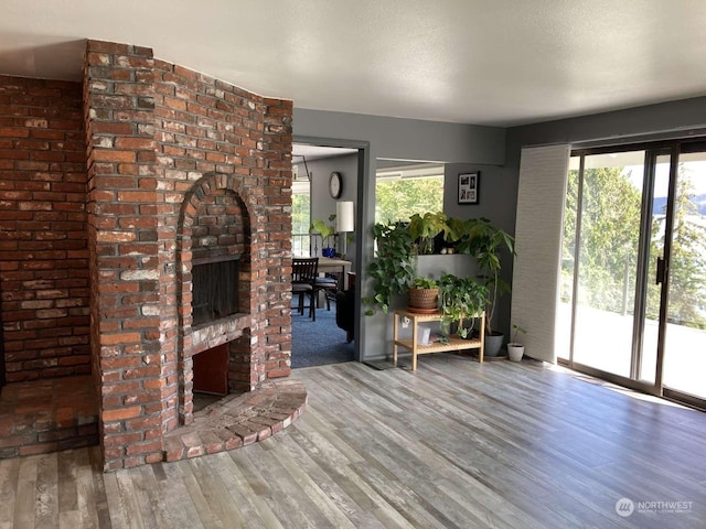 unfurnished living room featuring wood-type flooring and a fireplace