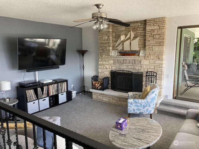 carpeted living room featuring ceiling fan, a textured ceiling, and a stone fireplace