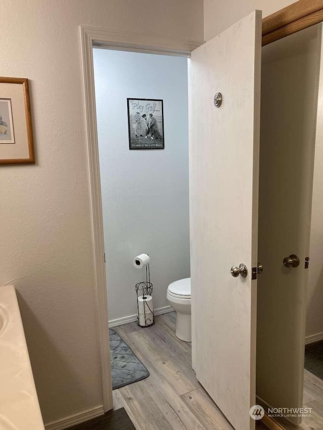 bathroom featuring toilet and hardwood / wood-style flooring