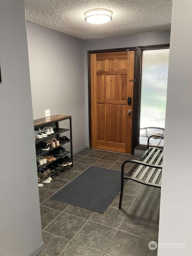 foyer entrance featuring a textured ceiling