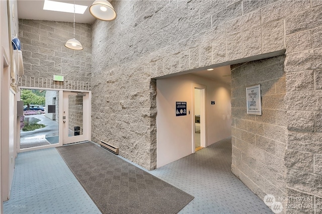 hall featuring a towering ceiling