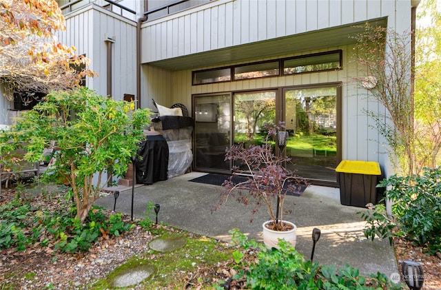 view of exterior entry featuring a patio