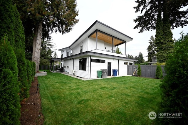 rear view of property with a lawn