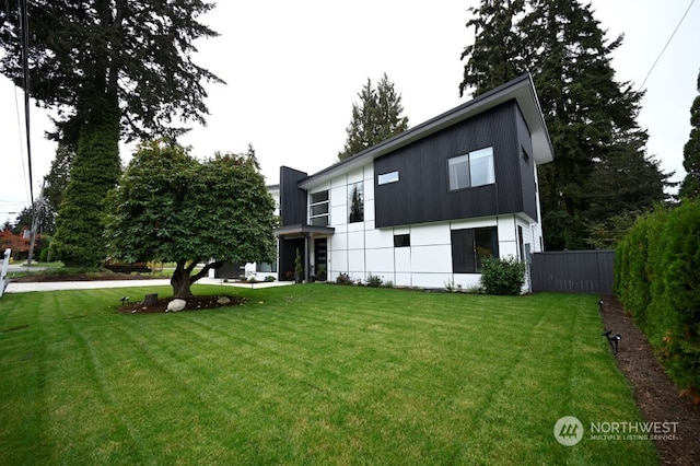 rear view of house with a lawn