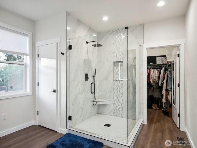 bathroom featuring an enclosed shower and wood-type flooring