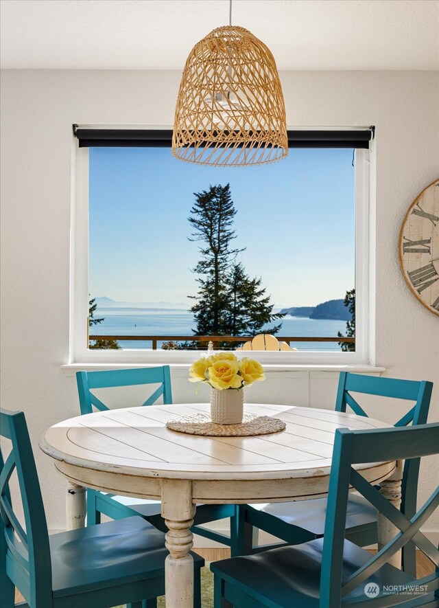 dining room featuring a water and mountain view