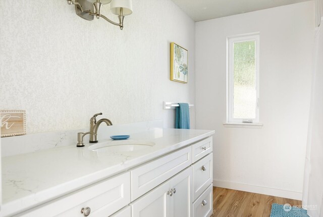 bathroom with vanity and hardwood / wood-style floors