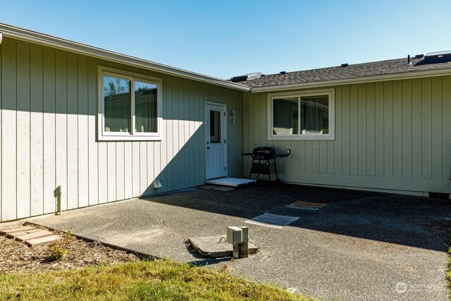 view of exterior entry featuring a patio