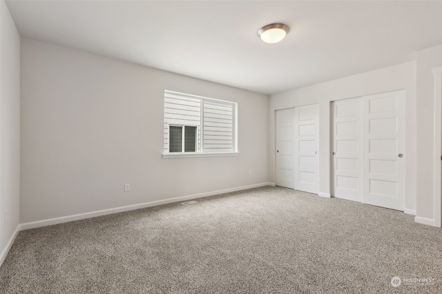 14727 88th Way SE Unit 18, Yelm, WA 98597 - unfurnished bedroom featuring baseboards, multiple closets, and carpet floors