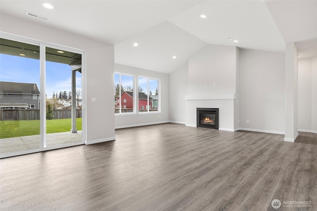 14727 88th Way SE Unit 18, Yelm, WA 98597 - unfurnished living room featuring recessed lighting, a glass covered fireplace, visible vents, vaulted ceiling, and wood finished floors