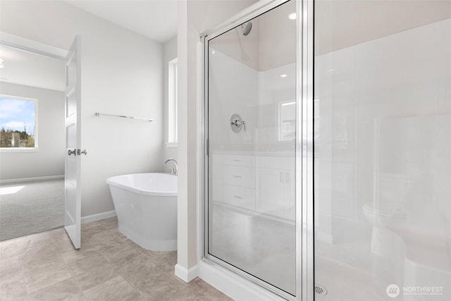 14727 88th Way SE Unit 18, Yelm, WA 98597 - full bathroom featuring a freestanding bath, plenty of natural light, baseboards, and a shower stall