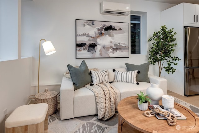 living room featuring light wood-type flooring and an AC wall unit