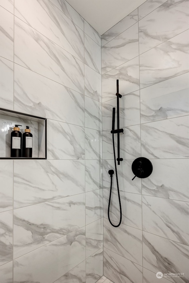 bathroom with tiled shower