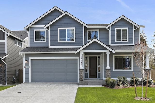 craftsman-style house featuring a front yard and a garage