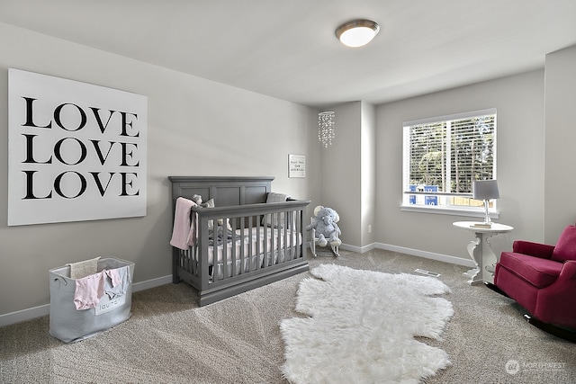 carpeted bedroom featuring a crib