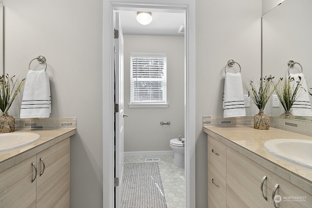 bathroom featuring vanity, tasteful backsplash, toilet, and tile patterned flooring