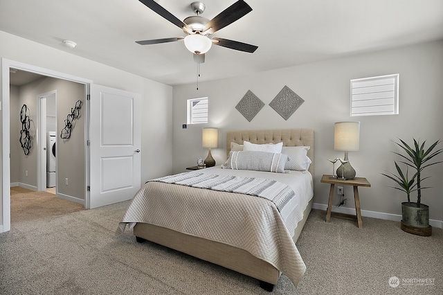 bedroom with light carpet, washer / clothes dryer, and ceiling fan