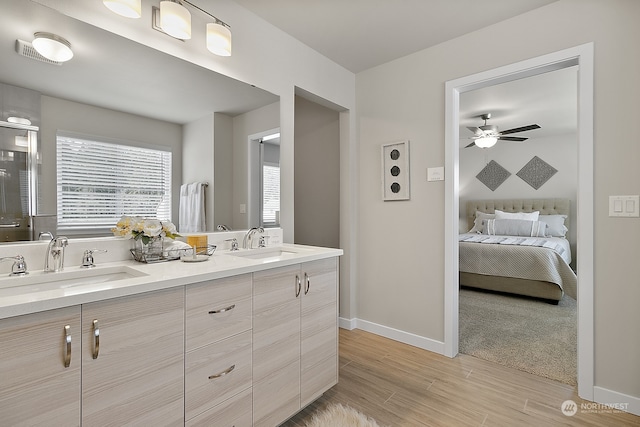 bathroom featuring vanity, hardwood / wood-style flooring, and ceiling fan