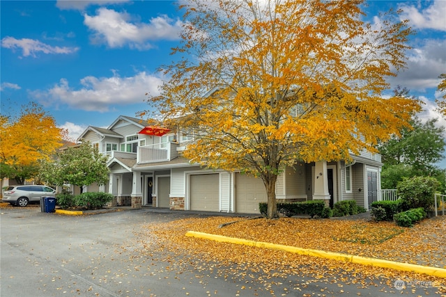 view of front of property with a balcony and a garage