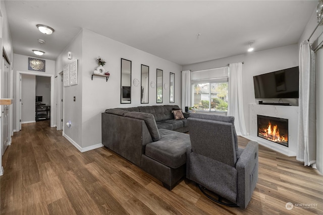 living room featuring a fireplace and dark hardwood / wood-style floors