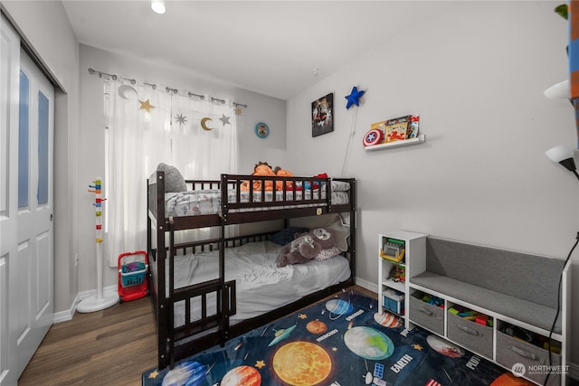 bedroom with dark hardwood / wood-style flooring