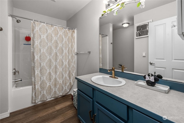 bathroom with shower / bath combo with shower curtain, hardwood / wood-style flooring, and vanity