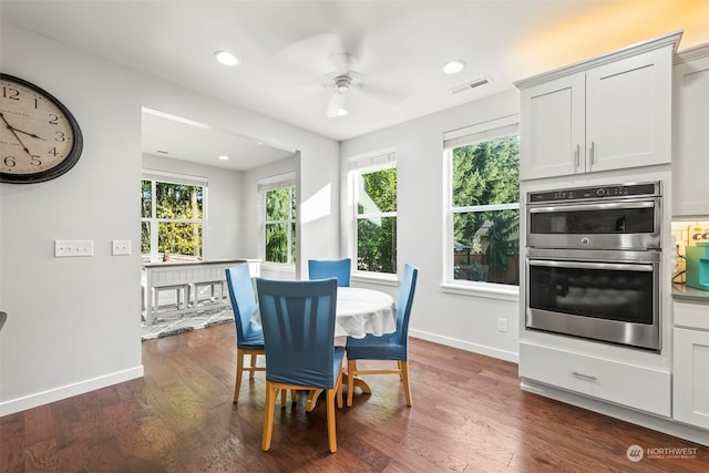 dining room featuring ceiling fan, dark hardwood / wood-style flooring, and a wealth of natural light