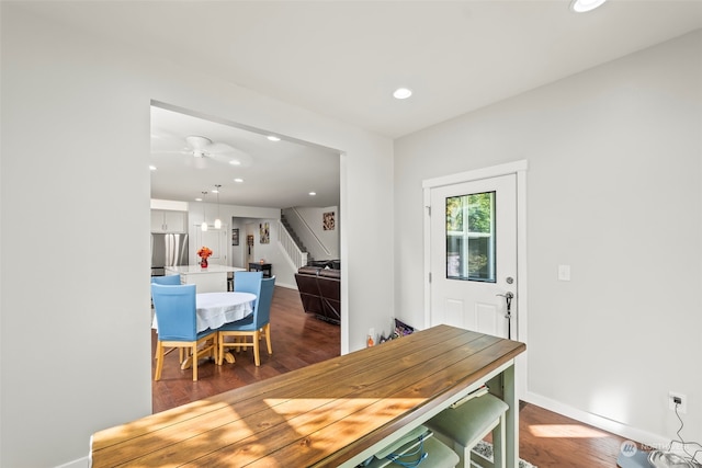 dining room featuring ceiling fan and dark hardwood / wood-style flooring