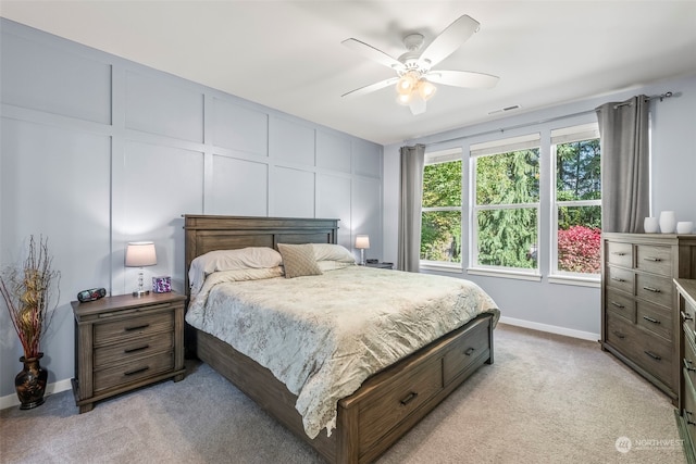 bedroom with ceiling fan and light colored carpet