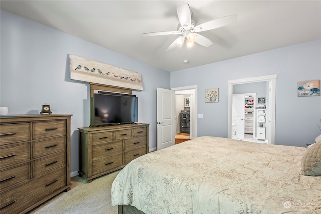 carpeted bedroom with ceiling fan and washing machine and clothes dryer