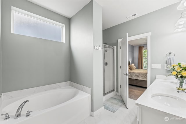 bathroom featuring sink and shower with separate bathtub