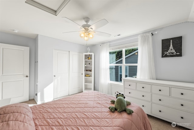 carpeted bedroom with lofted ceiling, a closet, and ceiling fan