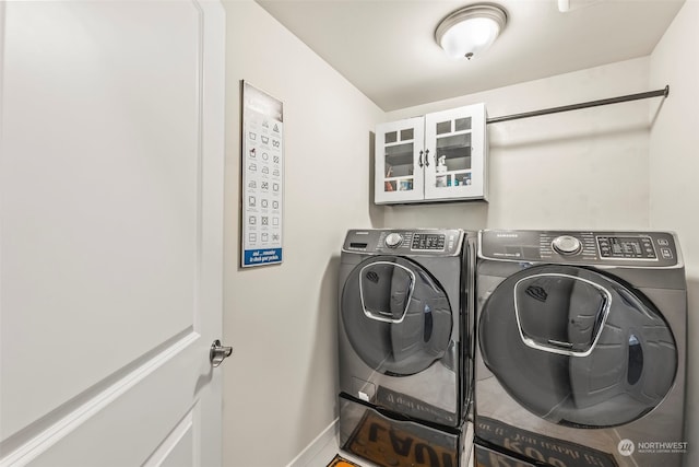 clothes washing area featuring washer and clothes dryer