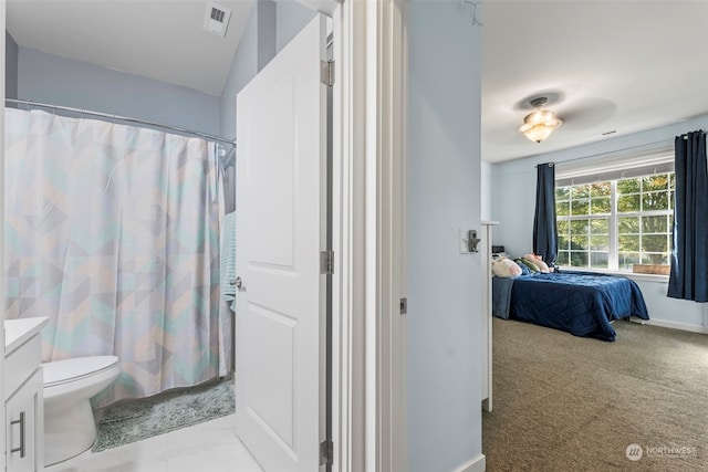 bathroom featuring curtained shower, vanity, and toilet